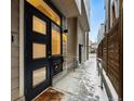 Eye-level exterior shot of the home's modern black front door and walkway at 4469 Tennyson St # 4, Denver, CO 80212