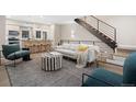 Sun-filled living room boasts hardwood floors, stylish decor, and contemporary finishes at 4469 Tennyson St # 4, Denver, CO 80212