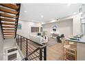 Bright and airy living room features hardwood floors and modern staircase at 4469 Tennyson St # 4, Denver, CO 80212