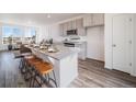 Modern kitchen with granite island, stainless steel appliances, and hardwood floors at 22052 E 38Th Pl, Aurora, CO 80019