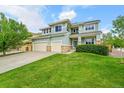 Charming two-story home boasts a well-manicured lawn and a convenient two-car garage at 3590 S Malaya St, Aurora, CO 80013