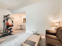 Open-concept living area with a fitness center and comfortable seating at 8236 Washington St # 29, Denver, CO 80229