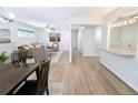 Spacious and modern living area with hardwood floors, leading to a well-lit hallway and kitchen at 420 E 104Th Pl, Northglenn, CO 80233
