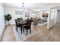 Bright open-concept living and dining area with hardwood floors and stylish decor at 420 E 104Th Pl, Northglenn, CO 80233