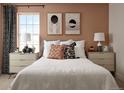 Comfortable bedroom featuring neutral tones, two bedside tables, and a large window at 24005 E Utah Pl, Aurora, CO 80018