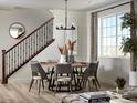 Cozy dining area with a modern chandelier and a round table, perfect for Gathering meals at 24005 E Utah Pl, Aurora, CO 80018