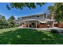 Expansive backyard showcasing a covered patio perfect for outdoor gatherings and summer grilling at 8696 E Easter Ave, Centennial, CO 80112