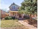 Charming two-story home with front porch and mature landscaping at 1741 N Emerson St, Denver, CO 80218