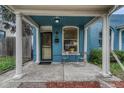 Charming blue home with a cozy front porch, complete with seating and a welcoming entrance at 132 W Bayaud Ave, Denver, CO 80223