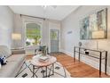 Cozy living room boasts hardwood floors, a decorative rug, and a bright window with natural light at 132 W Bayaud Ave, Denver, CO 80223