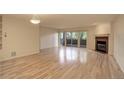 Bright living room with hardwood floors, fireplace, and sliding glass doors at 23619 Genesee Village Rd # B, Golden, CO 80401