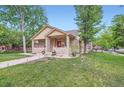 Attractive single-Gathering home with a covered porch and well-manicured lawn at 218 E Colorado Ave, Berthoud, CO 80513