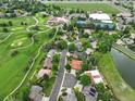 Aerial view showing neighborhood amenities including a pool, tennis courts, golf course, and nearby pond at 11621 Shoshone Way, Denver, CO 80234
