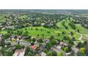 Wide aerial view of the neighborhood, highlighting the golf course, lush greenery, and community layout at 11621 Shoshone Way, Denver, CO 80234