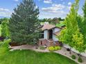 Aerial shot showcasing the well-maintained lawn, mature trees, and the home's architectural details at 11621 Shoshone Way, Denver, CO 80234