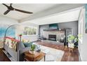 Cozy living room with fireplace, hardwood floors, and bright natural light at 6188 S Westview St, Littleton, CO 80120