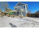 Two-story house with gray siding, covered porch, and snow-covered yard at 2728 Renshaw St, Strasburg, CO 80136