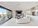 Bright living room with modern track lighting, sleek tile flooring, fireplace and access to a balcony at 1133 Race St # 8 & 9 B, Denver, CO 80206