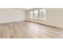 Bright living room with beautiful wood floors and large windows offering plenty of natural light at 22014 E 39Th Ave, Aurora, CO 80019