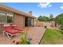 A brick patio with lounge chairs offers a relaxing outdoor space in this well-maintained backyard at 2800 S University Blvd # 1, Denver, CO 80210