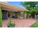 Charming covered patio with a brick floor and a porch swing, perfect for outdoor relaxation at 2800 S University Blvd # 1, Denver, CO 80210