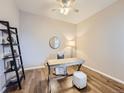 Cozy home office with hardwood floors, a modern desk setup, and a stylish ladder shelf at 12953 Bridge View Ln, Parker, CO 80134