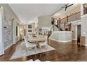 Bright dining area featuring hardwood floors, high ceilings, and elegant furnishings with view to kitchen at 970 Bend In The Trail Rd, Monument, CO 80132
