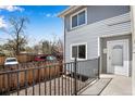 A sunny exterior view of a well-maintained home with clean lines, fenced yard and parking at 7845 Barbara Ann Dr # J, Arvada, CO 80004