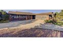 A large concrete driveway leading to a beautiful ranch-style home with an attached two-car garage at 20120 Doewood Dr, Monument, CO 80132