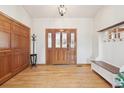 Inviting foyer with hardwood floors, a wood door and a coat rack, creating a warm and welcoming entrance at 20120 Doewood Dr, Monument, CO 80132