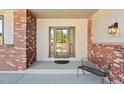 Cozy covered front porch with brick accents, offering a welcoming entrance to the home at 20120 Doewood Dr, Monument, CO 80132