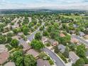 Wide aerial view of the neighborhood with tree-lined streets and well-kept homes at 2013 S Holland St, Lakewood, CO 80227