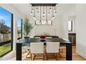 Bright dining area with a stylish chandelier, hardwood floors, and large windows for natural light at 380 S Humboldt St, Denver, CO 80209