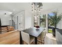 Dining room featuring a modern light fixture, wood floors, and view of the staircase and front entry at 380 S Humboldt St, Denver, CO 80209