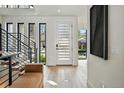 Bright foyer features wood floors, a bench and a staircase, creating a welcoming entrance at 380 S Humboldt St, Denver, CO 80209