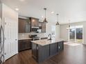 Modern kitchen with granite counters, stainless steel appliances, and a center island with pendant lighting at 18122 Tree Sparrow Ave, Parker, CO 80134