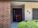 Entryway with red security door and view of brick exterior at 540 S Forest St # A2, Denver, CO 80246