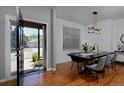 Elegant dining room featuring a modern table with stylish chairs and hardwood floors at 1735 Crestone Dr, Longmont, CO 80504