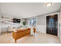 Bright living room featuring stylish wood-look flooring and shiplap accent wall at 7790 Kendall St, Arvada, CO 80003