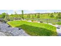 Well-maintained backyard with lush green grass, a fence, and professional landscaping at 6912 Sunstrand Ct, Castle Pines, CO 80108
