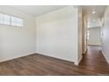 Bright bedroom with a light-filled window and stylish, dark wood-look flooring at 1923 Westport Ave, Berthoud, CO 80513