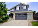 Stylish two-story home featuring a two-car garage, brick accents, and a beautifully maintained front yard at 2261 Alpine Dr, Erie, CO 80516