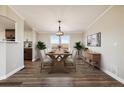 Bright dining room with hardwood floors and large windows at 43343 E Arkansas Pl, Bennett, CO 80102