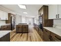 Modern kitchen with stainless appliances, quartz countertops, and an island at 43343 E Arkansas Pl, Bennett, CO 80102