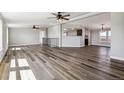 Open-concept living room boasts hardwood floors, ceiling fans, and natural light at 43343 E Arkansas Pl, Bennett, CO 80102