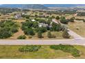A captivating aerial view of the property showcasing rolling hills and mature trees at 6334 Cherokee Dr, Sedalia, CO 80135