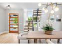 Modern entryway features an open staircase, light hardwood floors, and a stylish front door at 1500 S Elizabeth St, Denver, CO 80210