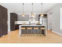 Bright kitchen with modern stainless steel appliances, a center island, and stylish pendant lighting at 1500 S Elizabeth St, Denver, CO 80210