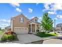 Inviting two-story home with a manicured lawn, attractive landscaping, and a welcoming facade at 5230 Periwinkle Way, Henderson, CO 80640