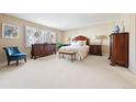Spacious bedroom with neutral carpet, traditional furniture, and a large window allowing for ample natural light at 4505 S Yosemite St # 106, Denver, CO 80237